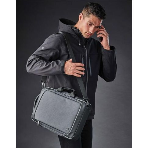 Stormtech Bags Road Warrior Computer Pack in Graphite Grey/Black across a man's shoulder