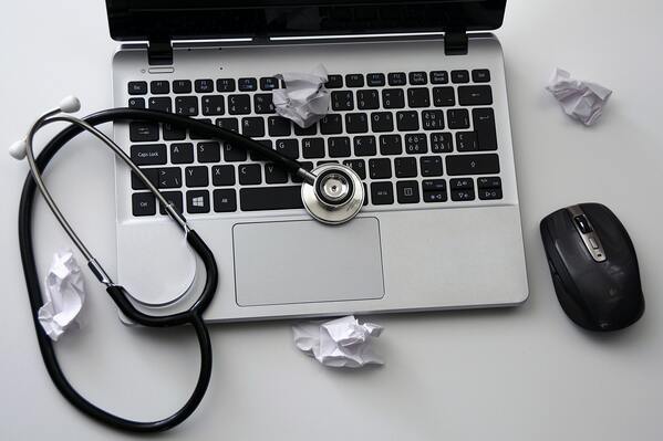 Image shows computer and stethoscope for occupational diseasestep