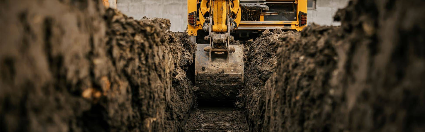 Groundworker digging a drainage ditch